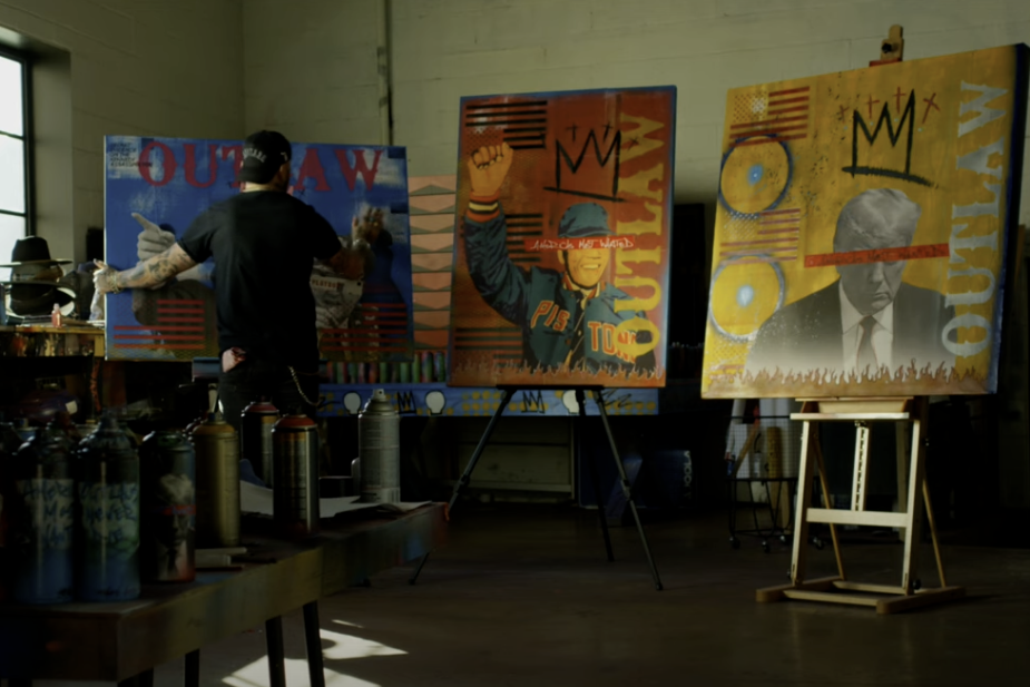 Travis Austin painting Outlaw canvases in art studio - Outlaws Never Die Travis Austin wearable art